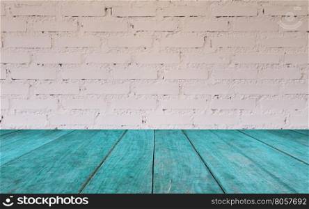 Blue wooden table top with brick wall decorated in coffee shop