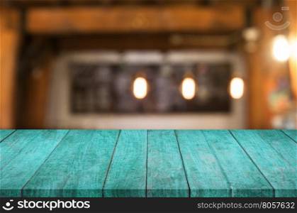 Blue wooden table top with coffee shop blurred abstract background