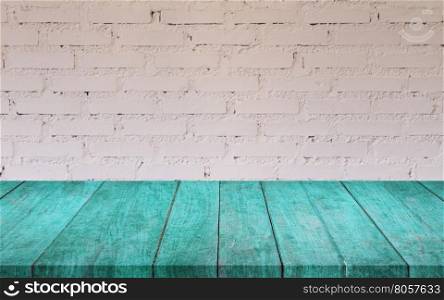 Blue wooden table top with white brick wall decorated in coffee shop