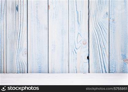 Blue wooden wall, painted in shabby chic style and white floor