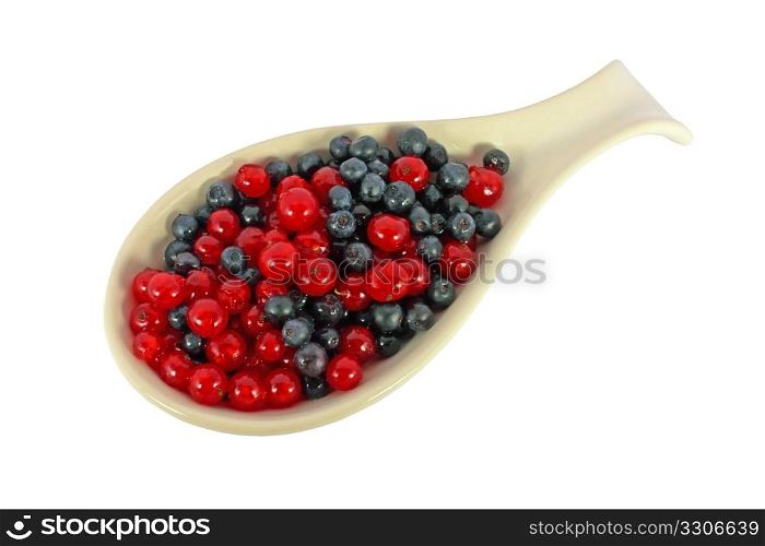 Blueberries and currants in a scoop isolated on white