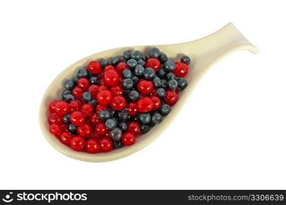 Blueberries and currants in a scoop isolated on white