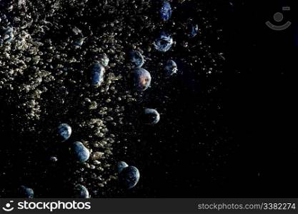 Blueberries floating in water with bubbles