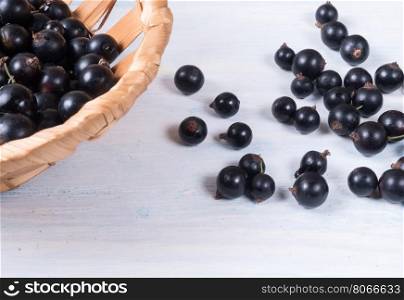 Blueberries in a basket on wooden background.. Blueberries in a basket