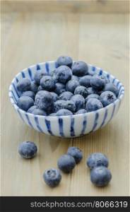 Blueberries in a bowl. Blueberries in a bowl on a wooden background