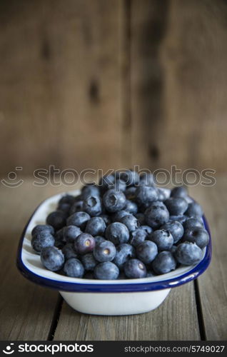 Blueberries in rustic setting with old wooden background