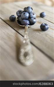 Blueberries in rustic setting with old wooden background