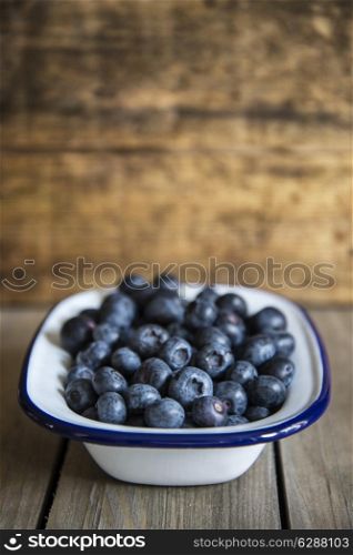 Blueberries in rustic setting with old wooden background
