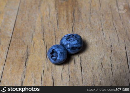 Blueberries on a blue wooden background, close up