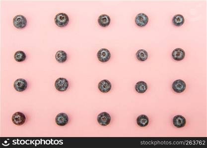 blueberries on a pastel pink background