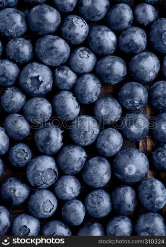 Blueberries on grunge wooden kitchen board. Natural healthy food. Still life photography