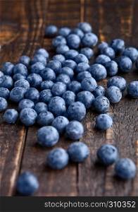 Blueberries on grunge wooden kitchen board. Natural healthy food. Still life photography