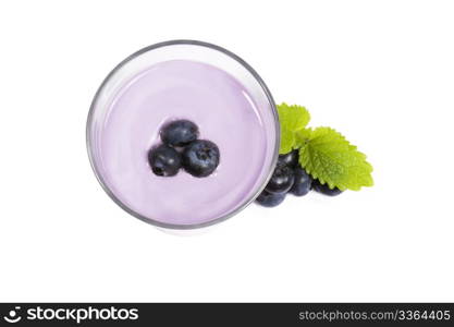 blueberries on top of a blueberry milkshake with blueberries aside. blueberries on top of a blueberry milkshake with blueberries and melissa aside on white background