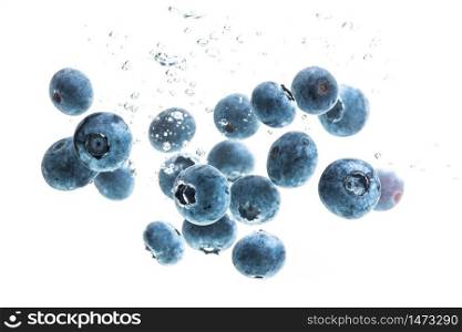 Blueberries sinking underwater with air bubbles isolated on white background. Antioxidant fruit theme.. Blueberries sinking underwater with air bubbles isolated on white background
