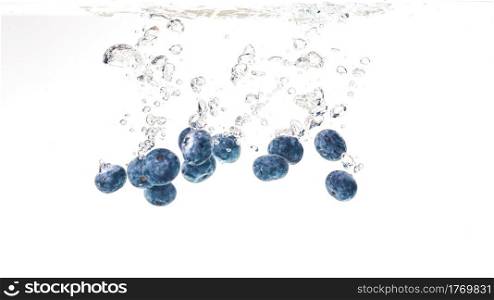 Blueberries splashing in water on white background. Blueberries splashing in water on white
