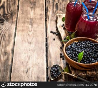 Blueberry fresh juice . On a wooden table.. Blueberry juice . On wooden table.