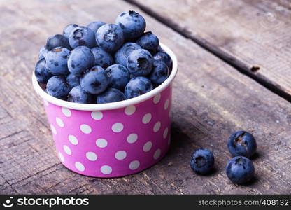 blueberry in a cheerful bright glass at the wooden background