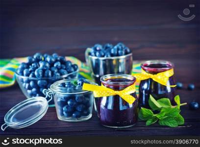 blueberry jam in glass bank and on a table