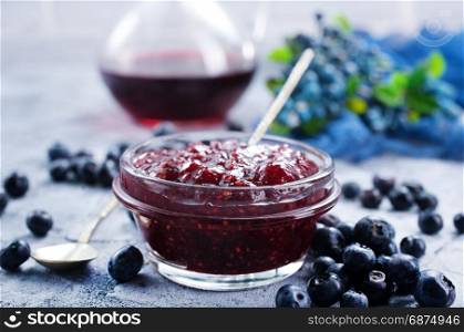 blueberry jam in glass yar and on a table