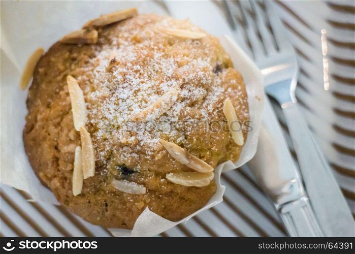 Blueberry muffin serving with knife and fork, stock photo