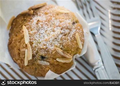 Blueberry muffin serving with knife and fork, stock photo