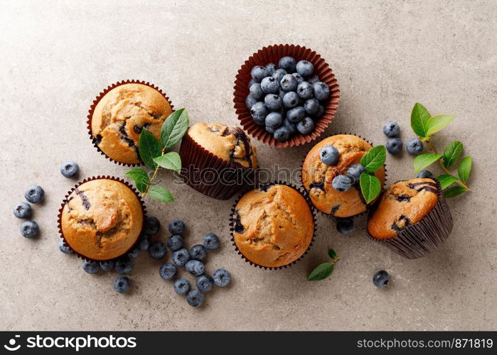 Blueberry muffins with fresh berries, top view