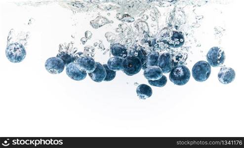 Blueberry&rsquo;s splashing into crystal clear water with air bubbles