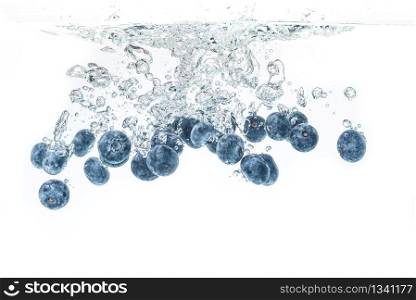 Blueberry&rsquo;s splashing into crystal clear water with air bubbles