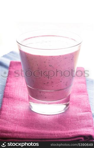 blueberry smoothie in a glass on the table