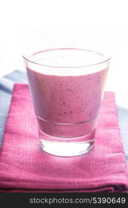 blueberry smoothie in a glass on the table