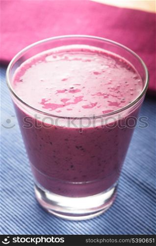 blueberry smoothie in a glass on the table