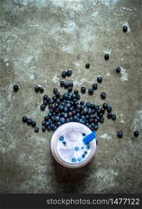 Blueberry smoothie with ice. On a stone background.. Blueberry smoothie with ice. On stone background.