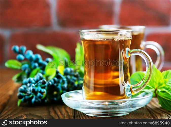 blueberry tea in cup and on a table