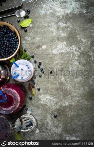 Blueberry with blueberry smoothies and juice. On the stone table.. blueberry smoothies and juice