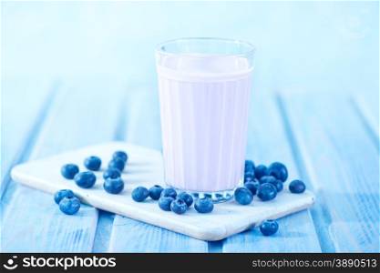 blueberry yogurt in glass and on a table