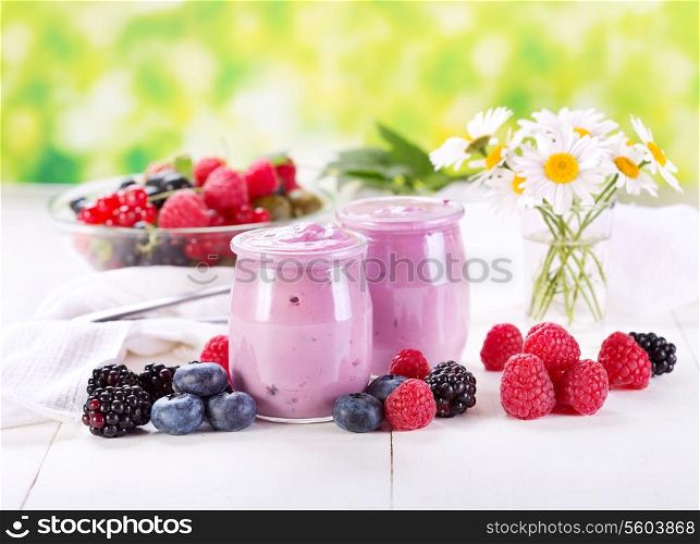 blueberry yogurt with fresh berries on wooden table