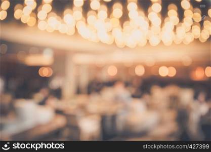 Blur abstract bokeh light background with restaurant or coffee shop or pub modern luxury style with people celebrate and dinning warm tone. For create montage product display.