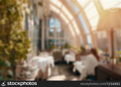 Blur background luxury cafe or restaurant interior with vintage style tone
