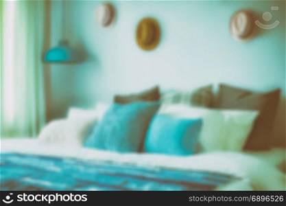 blur image of blue color scheme teenager bedroom with hats on wall decoration