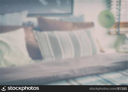 blur image of brown and gray color scheme bedding with reading lamp