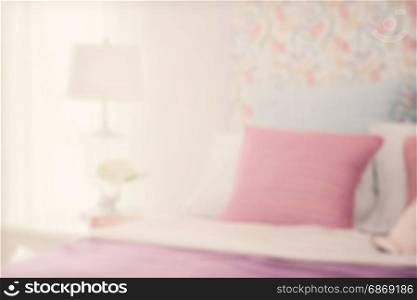 blur image of colorfull bedding style with reading lamp