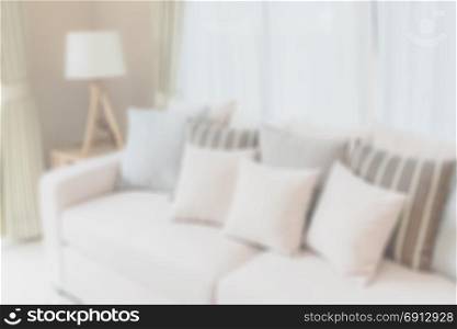 blur image of modern living room design with sofa and wooden lamp