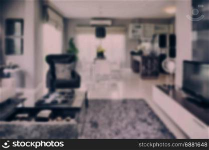 blur image of modern living room interior with dining table and pantry at home