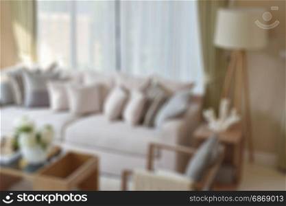 blur image of modern living room with sofa and lamp at home