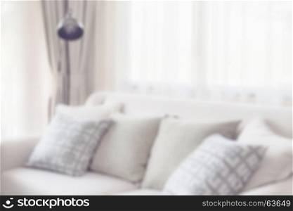 blur image of pillows on sofa in modern living room
