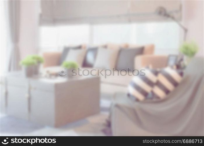 blur image of striped and black leather pillows on the sofa in modern industrial style living room