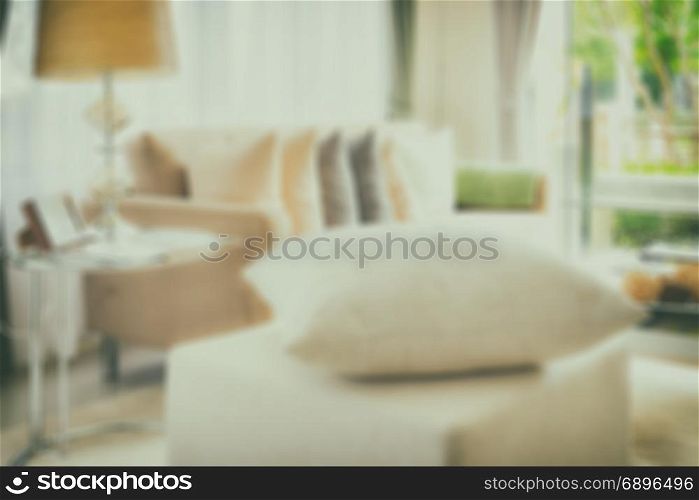 blur image of white pillow on stool in modern living room interior