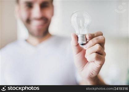 blur man showing transparent light bulb