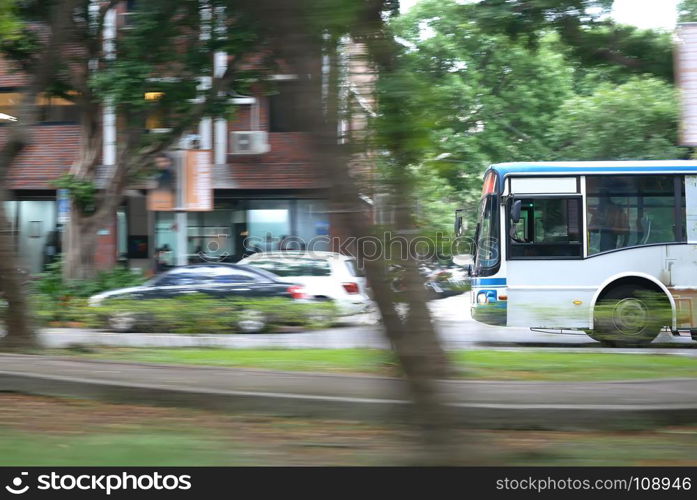 Blur motion of bus driving on road during rush hour