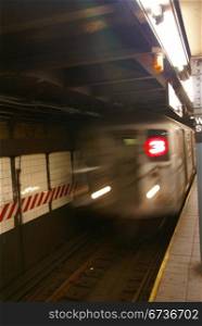 Blur of approaching subway, New York City
